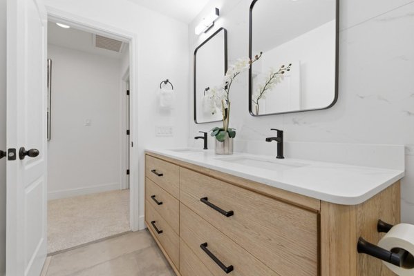 Primary bathroom · Danville - Primary bathroom remodel in Danville, featuring a white oak double vanity, black fixtures, a freestanding tub, and a glass shower.