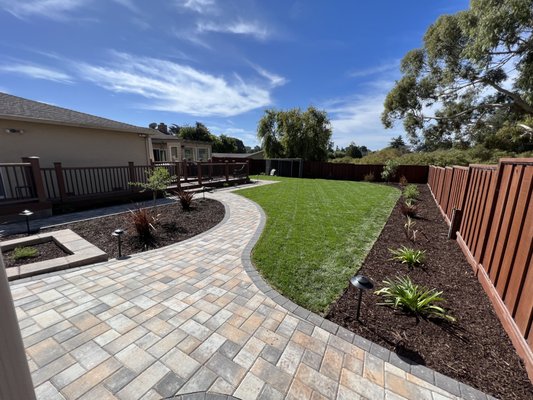 Backyard Landscaping Installation - This backyard renovation included new sod installation, irrigation system, paver walkway, retaining wall, and new planting. Backyard Landscaping Installation - This backyard renovation included new sod installation, irrigation system, paver walkway, retaining wall, and new planting.
