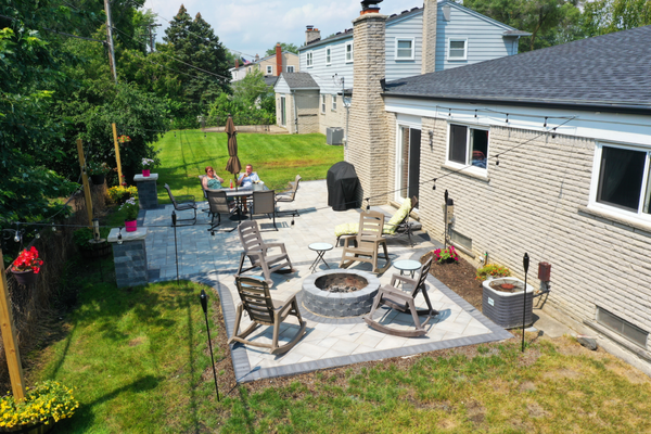Brick Paver Patio with Fire Pit | Southfield, MI - PMS Brick Pavers created this beautiful outdoor living space for our client in Southfield, MI. It has a beautiful design, flow, and color. It is structurally sound and built to repel water and last for decades. The fire pit was created as a space for family and friends to gather as the night winds down. We completed this project in just one day and the customer was overjoyed!