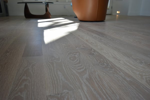 6th Ave - Solid White Oak with Hardwax Oil - This project featured a new installation of 5-inch wide white oak flooring over a radiant heat system, creating a seamless and modern look while maintaining warmth and comfort.

One of the biggest challenges was working with an uneven subfloor that had multiple substrate types due to previous remodels. Since the cabinets and appliances were staying in place, we had to ensure the new flooring remained at the existing height, limiting our ability to raise or rework the subfloor.

To overcome these challenges, we meticulously leveled the different sections, ensuring a smooth and stable foundation for the new flooring. The result is a beautifully installed, durable hardwood floor that enhances the space while allowing the radiant heat system to function efficiently.