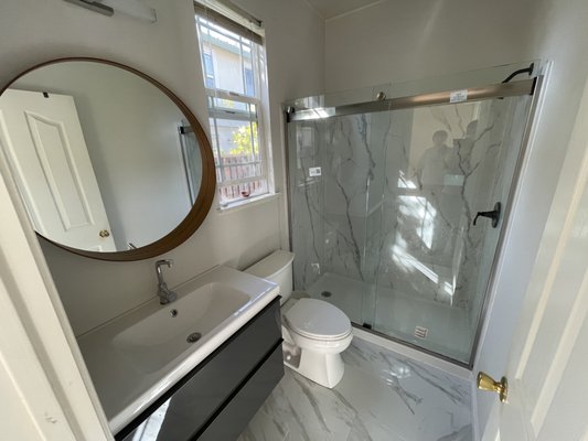 BATHROOM REMODEL - THIS REMODEL WAS DONE ON OUTDATED BATHROOM WITH NEW SHOWER PANELS, NEW SLIDING SHOWER DOORS, NEW VANITY AND FLOOR TILE