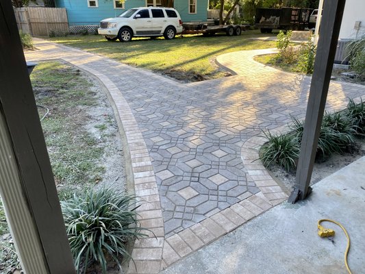 Custom Sidewalk and Patio - Travis and his wife wanted to utilize some old brick pavers in their yard for a sidewalk and patio. They called in the Paver Kings and we custom built them an elegant patterned walkway with a matching patio. This was a very difficult project with thousands of custom cuts, but we were able to accomplish this in only 3 days. Now they can walk around their house without getting mud on their boots! Custom Sidewalk and Patio - Travis and his wife wanted to utilize some old brick pavers in their yard for a sidewalk and patio. They called in the Paver Kings and we custom built them an elegant patterned walkway with a matching patio. This was a very difficult project with thousands of custom cuts, but we were able to accomplish this in only 3 days. Now they can walk around their house without getting mud on their boots!
