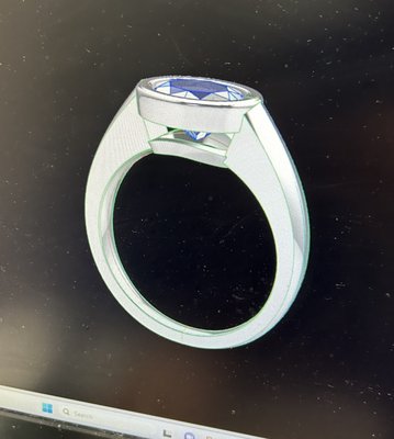 Custom Ring Design - Our client asked us to design this modern ring around a sapphire stone that was given to her from years past. The 18k white gold finish truly accentuates the natural blue radiance of the precious stone. Custom Ring Design - Our client asked us to design this modern ring around a sapphire stone that was given to her from years past. The 18k white gold finish truly accentuates the natural blue radiance of the precious stone.