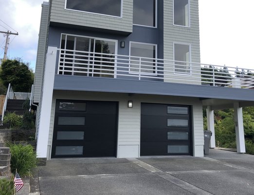 'MODERN TECH' GARAGE DOOR INSTALLATION - In this project, we updated the look of these old wooden garage doors with 2 new fully insulated Modern Tech garage doors with frosted glass. This particular door is available in many different window configurations and glass types. Call Absolute Garage today if you would like to see doors like these on your home!