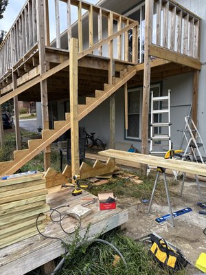 Deck remodel - When we came to this house, he had already built the upper section and he did not have adequate posts large enough to be able to hold all the weight. Using all of the two by fours he did as his balusters made the handrailings twice as heavy. Six by sixes should’ve been used for post instead of 4 x 4’s so we put T braces underneath to take someone the weight of the deck and put it on the braces rather than on the ledger board and the 4” x 4”’s. So we did 6 x 6 T braces we wanted to put them where the concrete walkway is, but that wasn’t desired by the client so we met in the middle and went in front of the concrete. It’s not carrying as much of weight as I would’ve liked, but at least we got some of the weight off the house and onto the braces. We also built stairs and handrails. We had to modify the landing at the bottom. Deck remodel - When we came to this house, he had already built the upper section and he did not have adequate posts large enough to be able to hold all the weight. Using all of the two by fours he did as his balusters made the handrailings twice as heavy. Six by sixes should’ve been used for post instead of 4 x 4’s so we put T braces underneath to take someone the weight of the deck and put it on the braces rather than on the ledger board and the 4” x 4”’s. So we did 6 x 6 T braces we wanted to put them where the concrete walkway is, but that wasn’t desired by the client so we met in the middle and went in front of the concrete. It’s not carrying as much of weight as I would’ve liked, but at least we got some of the weight off the house and onto the braces. We also built stairs and handrails. We had to modify the landing at the bottom.