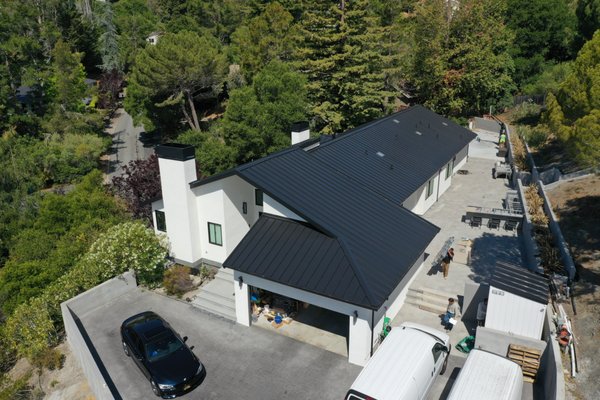 Standing Seam In Hillsborough - This home was being remodeled and needed a roof to match. We came in and installed a beautiful Matte Black SS550 standing seam roof, complete with specially flashed sun tunnels, gutters, and two chimney covers that were custom fabricated by our in-house metal shop. Contact us today for a competitive standing seam estimate! Standing Seam In Hillsborough - This home was being remodeled and needed a roof to match. We came in and installed a beautiful Matte Black SS550 standing seam roof, complete with specially flashed sun tunnels, gutters, and two chimney covers that were custom fabricated by our in-house metal shop. Contact us today for a competitive standing seam estimate!