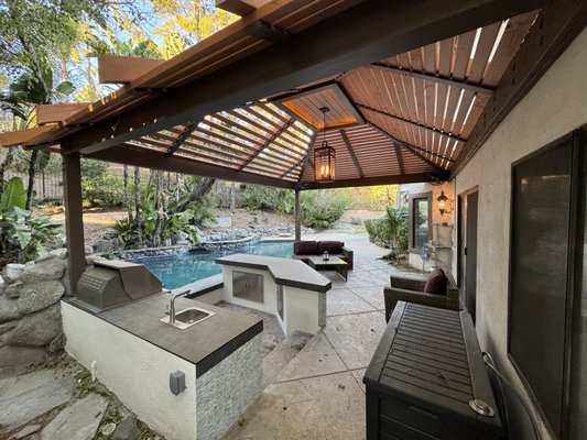 Custom wood patio cover. Outdoor kitchen. Pool bar. - Discover the art of outdoor living with our latest project: a charming custom wood patio, complete with a fully equipped outdoor kitchen and a stylish poolside bar. Watch as we craft the perfect space for entertaining and relaxing under the sun. From the sturdy construction of the patio to the custom design of the kitchen and bar, every detail is thoughtfully executed to create the ultimate backyard retreat.