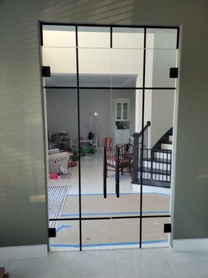 Double glass door with aluminum grids and hydralic hinges - The customer wanted something very clean and elegant and wanted his glass doors to properly have self centering hydralic hinges with a mechanism for adjustable speeds. Double glass door with aluminum grids and hydralic hinges - The customer wanted something very clean and elegant and wanted his glass doors to properly have self centering hydralic hinges with a mechanism for adjustable speeds.