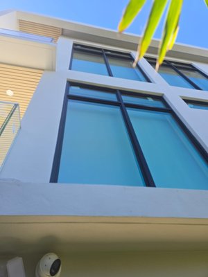 Windows - This is a brand-new construction. The house is 3 stories high with all impact windows and sliding doors. Bronze frame.
