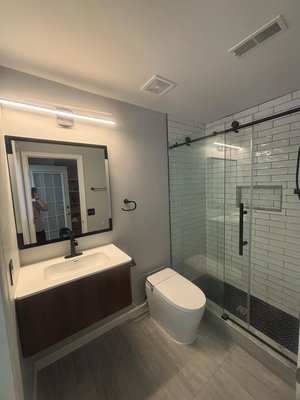Walk-in Shower - This was a full renovation, tub to shower conversion. Black and white bathroom with a smart mirror, floating vanity and bidet.