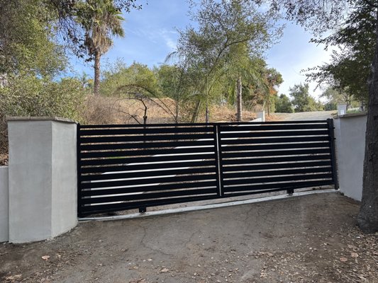 Custom Sliding Entry Gate and Double Swing Gate - We’re proud to showcase a recent project featuring two custom farm style gates designed with a cohesive aesthetic. This installation includes a sliding entry gate and a double drive gate, each custom fabricated to fit the property precisely.
The design balances strength, security, and visual appeal, enhancing both functionality and curb appeal. For homeowners seeking a professional, long-lasting entry solution, custom metal gates offer a refined, durable, and elegant option. Custom Sliding Entry Gate and Double Swing Gate - We’re proud to showcase a recent project featuring two custom farm style gates designed with a cohesive aesthetic. This installation includes a sliding entry gate and a double drive gate, each custom fabricated to fit the property precisely.
The design balances strength, security, and visual appeal, enhancing both functionality and curb appeal. For homeowners seeking a professional, long-lasting entry solution, custom metal gates offer a refined, durable, and elegant option.
