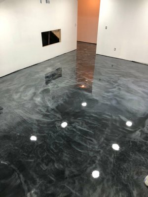 Metallic Epoxy - Are you looking for a new floor that is not only beautiful but durable as well? Metallic epoxy floors are one of the most durable flooring systems available. They can withstand high traffic and damage from most chemicals, fluids and heat. From the garage to the basement, metallic epoxy floors add elegance and strength to any room in your home or business.