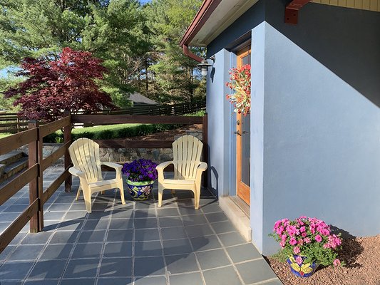 Colorful Outdoor Living - Colorful stonework and plantings elevate the outdoor ambiance for a home where color is king