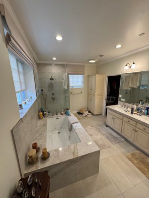 Beverly Hills - Full Master Bathroom Remodel - Complete master bathroom gut remodel on a high-end estate. Scope included leak investigation and wall opening from a failed original shower pan, full demo with on-site property protection, new framing, custom jacuzzi tub platform, waterproofing membrane, full marble tile on floors, tub surround and shower walls, frameless glass enclosure, Brizo fixtures, recessed lighting, and double vanity with marble countertop. Full GC management.