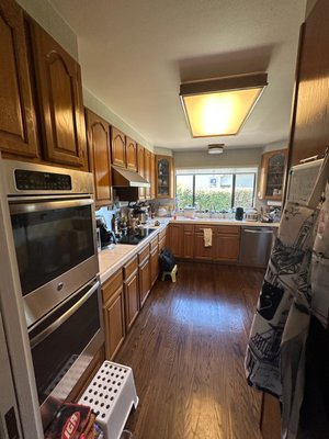 Refinish Millbrae - Updated Old Oak Cabinets, Refaced to A Bright White, New Lighting and New Counters and Backsplash.