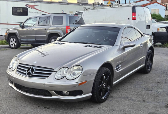 2005 Mercedes-Benz SL-Class - Experience luxury and performance with the 2005 Mercedes-Benz SL-Class. This iconic roadster features a powerful engine, refined styling, and a retractable hardtop for open-air driving. With comfortable leather seating, advanced features, and timeless design, the 2005 SL-Class delivers an elegant and exhilarating ride for those who appreciate both sophistication and excitement.
