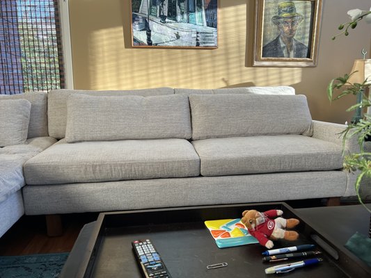 Sofa Repair and White Glove Delivery - Following our initial inspection identifying structural failure caused by degraded cedar framing and insufficient factory fastening, Luggit has completed a comprehensive remediation of the sofa's support system.

Contrary to a standard repair, this project involved a complete rebuild of the spring support infrastructure. Our objective was to not only restore the piece but to upgrade its structural integrity to withstand normal residential use for years to come. We eliminated all compromised materials—leaving no damaged or suspect members intact—and reinforced high-stress zones to prevent history from repeating itself.

1. Structural Material Upgrade (Red Oak Implementation)

The primary cause of the initial failure was the factory's use of low-density cedar, which suffered from internal rot and fiber separation.

Removal: We completely excised the failed cedar framing components and the adjacent support member identified as "suspect" during the inspection.

Upgrade: We fabricated replacement structural members from solid Red Oak. We selected this hardwood for its superior density and compressive strength compared to the original soft cedar.
Installation: Three primary support slats were installed in optimal load-bearing positions, ensuring vertical seating forces are now distributed evenly across the frame rather than concentrated on two weak points.

2. Connection Reinforcement & Fastener Remediation

The inspection revealed that the factory utilized friction-based wire nails, which pulled out under tension. We have converted the frame to a mechanically locked system.

Hardware: We replaced the original connections with steel Sampson Strong-Tie brackets and GRK T-Star structural fasteners.

Stability: This upgrade significantly increases resistance to lateral shear (side-to-side movement) and torsional movement (twisting). All reinforcement members were seated flush to eliminate frame flexion.

3. Spring System Reconstruction

To address the spring alignment issues noted in the inspection, we performed a total reconstruction of the spring rail system.

Reinforced Rail: We built a triple-reinforced rail system to spread spring tension across multiple attachment points.

Hardware Upgrade: Damaged sinuous spring clips were removed and replaced with upgraded boxed spring hangers. These incorporate HDPE (high-density polyethylene) wear protection to reduce metal-on-wood abrasion—a common source of squeaking and wear.

Alignment: All sinuous springs were reset to proper tension, ensuring consistent load transfer and uniform seat travel.

5. Upholstery Restoration & Verification

We accessed the internal framing by carefully separating the upholstery layers to avoid damage to the primary seating surfaces.

Reattachment: The seat base, front rail, and rear backing were reattached using industrial staples at the correct depth for load-bearing assemblies.

Detailing: Localized fabric stress caused by the previous frame displacement was stabilized using hand-executed ladder stitching to prevent tearing.

Seal: A new cambric dust cover was installed to seal the underbody and protect the new frame.
