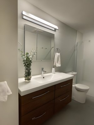 Tina's bathroom (curbless shower) - My client had an unfinished basement. She hired me to frame, insulate, drywall and trim the basement. I also installed a small Ikea kitchen. I created a new bathroom featuring a curbless shower. There are a couple of custom details she wanted such as a concealed door, a concealed linen closet and a floating shelf. Tina's bathroom (curbless shower) - My client had an unfinished basement. She hired me to frame, insulate, drywall and trim the basement. I also installed a small Ikea kitchen. I created a new bathroom featuring a curbless shower. There are a couple of custom details she wanted such as a concealed door, a concealed linen closet and a floating shelf.