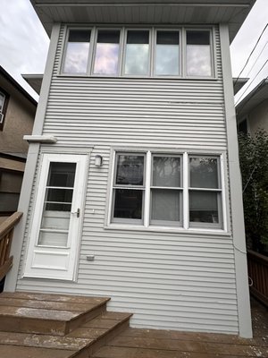 House Exterior Painting in Deerfield & Before and After - Serving Chicago and Suburbs including West Loop, Lincoln Park, Lakeview, North Center, Roscoe Village, Logan Square, Evanston, Wilmette, Winnetka, Glencoe, Glenview, Northbrook, Highland Park, Deerfield, Lincoln Square, West Town, The Loop, Near North Side, Bucktown, Avondale, Oak Brook, Elmhurst, Hinsdale, and more.

This recent exterior painting project was completed by Handy Hero LLC in Deerfield, IL. The house had old, weathered siding that showed years of exposure to Chicago’s tough climate — fading paint, peeling areas, and uneven texture across the surfaces. Our goal was to restore the property’s clean, elegant look and ensure long-term durability.

We started with a detailed preparation process. All surfaces were power-washed to remove dirt, mildew, and chalk residue. Next, we thoroughly scraped all peeling areas and repaired minor imperfections to achieve a smooth, consistent base. Caulking was applied to all gaps and seams to improve insulation and protect against moisture. Once the preparation was complete, a professional primer coat was applied to ensure strong paint adhesion and extended paint life.

For the finish, we used high-quality acrylic exterior paint from Sherwin-Williams, chosen for its color retention, UV resistance, and ability to withstand Chicago’s changing weather. Two full coats were applied for complete coverage and a uniform, long-lasting appearance. Every window frame, corner board, and trim detail was carefully brushed and rolled to perfection.

The result speaks for itself — a fresh, clean, and modern exterior that completely transformed the back elevation of the home. The siding now looks new, the trim lines are crisp, and the overall look of the property is brighter and more inviting. This type of meticulous work not only enhances curb appeal but also protects the structure for years to come.

At Handy Hero, we take pride in providing premium-quality workmanship backed by our 365 Days Workmanship Guarantee. Every client receives the same level of care and attention to detail, from the first consultation to the final inspection. We also offer Free Estimates, so homeowners can explore their options with confidence and no obligation.

Our company is fully insured with One Million Dollar Coverage — giving our clients peace of mind that every project is professionally handled from start to finish. Whether you’re refreshing a single wall or repainting an entire home exterior, you can count on Handy Hero to deliver durable results that last through every season.

In Deerfield, this project demonstrated how a well-planned exterior painting job can completely rejuvenate the look of a home. Years of fading paint and moisture damage were replaced with a clean, uniform surface that will protect the structure through rain, snow, and sun. It’s another great example of how our team combines engineering precision with real craftsmanship.

Handy Hero LLC is owned and operated by a certified engineer with more than 9 years of experience in construction and home improvement. We handle every project — large or small — with the same commitment to quality, safety, and customer satisfaction. From meticulous surface preparation to professional paint application, our process is designed for results that exceed expectations.

If you’re in Chicago or nearby suburbs and need a reliable handyman or professional painting service, contact Handy Hero today. We specialize in interior and exterior painting, drywall repair, TV mounting, furniture assembly, light fixture installation, and much more. Every service is performed with honesty, transparency, and guaranteed workmanship.

Let your home stand out with a professional finish that adds both beauty and protection. Schedule your free estimate today and experience the difference with Handy Hero — where quality meets reliability, and every project is completed with pride.