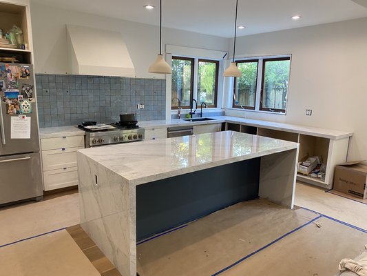 Chris’s Kitchen countertop and waterfall - For Chris’s kitchen we used the Calacatta calcite (Porcelain) Chris’s Kitchen countertop and waterfall - For Chris’s kitchen we used the Calacatta calcite (Porcelain)