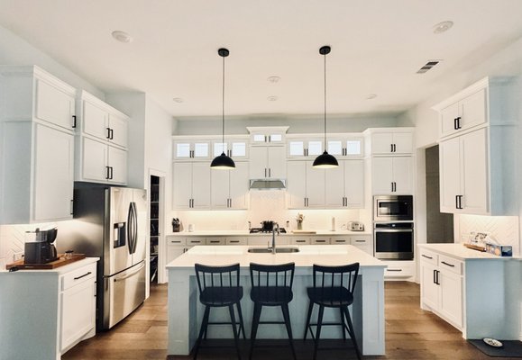 Kitchen Remodel - This custom kitchen cabinetry project in Frisco, Texas gave the homeowner the additional storage and finished look they were looking for. Our team designed, built, installed, and painted custom kitchen stacker cabinets that seamlessly matched the existing cabinetry, creating a cohesive, built-in appearance from countertop to ceiling.

To complete the project, we carefully removed and reinstalled the existing crown molding, ensuring a flawless transition between the new cabinetry and the original kitchen design. The new shaker-style cabinets were custom painted to match the existing finish and built with soft-close hinges for smooth, quiet operation and lasting durability.