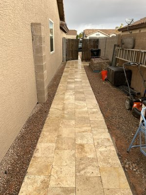 Paver and Travertine installation. - Installed new backyard patio, grass border and walkway for shed. Also installed a front walkway out to the street sidewalk. Installed travertine walkway from front driveway along side of house connecting to back patio. Also installed 5 tons of new decorative granite rock.