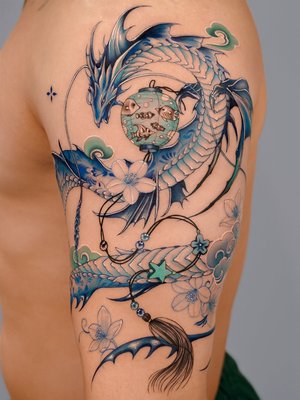 Dragon/Snake - Vism Studio's dragon and snake tattoos are masterful compositions that intertwine mythological symbolism with meticulous artistry. These designs often feature serpentine forms rendered in fine lines and intricate shading, capturing the dynamic interplay between power and grace in each piece.