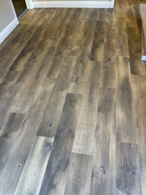 Mohawk Rev Wood floating installation. - This project involved removal of existing tile and engineered glued wood.  Installation of floating Mohawk Rev wood and new baseboards.