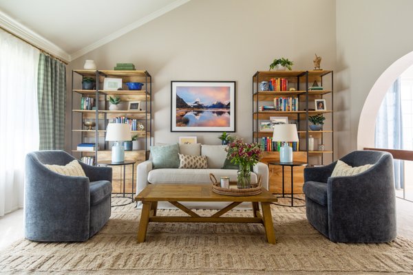 Rom-Com-Cozy Front Room, Orange - Bring on the cozy! We updated this underused front room with some Nancy Meyers inspired style (picture the dreamy sets of The Holiday and Parent Trap movies). Selecting pieces that worked with this young couple’s existing furniture and pet-friendly lifestyle allow them to regularly use this room. Now they have a cozy haven for novel reading, a workout spot for morning yoga, and an evening phone-scrolling lounge with their pups. We’re delighted to give them a space that is bursting with personal touches, and we think you’ll love it too! Rom-Com-Cozy Front Room, Orange - Bring on the cozy! We updated this underused front room with some Nancy Meyers inspired style (picture the dreamy sets of The Holiday and Parent Trap movies). Selecting pieces that worked with this young couple’s existing furniture and pet-friendly lifestyle allow them to regularly use this room. Now they have a cozy haven for novel reading, a workout spot for morning yoga, and an evening phone-scrolling lounge with their pups. We’re delighted to give them a space that is bursting with personal touches, and we think you’ll love it too!