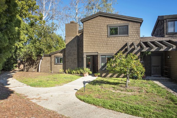 Live in Santa Barbara! - Spacious 4 bedroom, 2.5 bathroom home in the Cathedral Oaks Village! This end unit boasts updated kitchen with cozy breakfast room and semi-formal dining room. The light and bright dining room opens up via French doors to a sunny wrap around patio, & is also open to the living room with fireplace & views of the front yard. The ground floor bedroom also has views of the front yard, and is set up nicely to be used as a home office. Upstairs features 2 bedrooms & a Main Bedroom with en suite bathroom and large skylight for warm natural light. Located in the Kellogg school district, this unit enjoys an extra custom storage room and all of the amenities that the private community has to offer - fruit trees, pool, 2 tennis courts, clubhouse, walking paths, and ample assigned & guest parking.