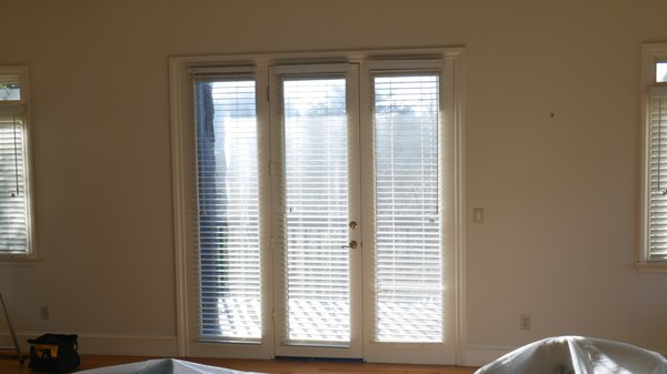 French Doors Added to Living Room - This San Rafael home owner had a single glass door with two glass side panels leading to a balcony with a fabulous view of San Rafael. The door was tired and not very inviting.  It also divided the view outside.  It had to go.  In its place went a fiberglass and wood ousting french door from Marvin.  The new door completely changes the look and feel of the living room.  It invites guests to enjoy the balcony.  It lets more light into the room and offers brings the outside in when opened fully.  The result is truly transforming.  The door was installed in one day by our Master Craftsman Installer, Aldrin.  Great job!