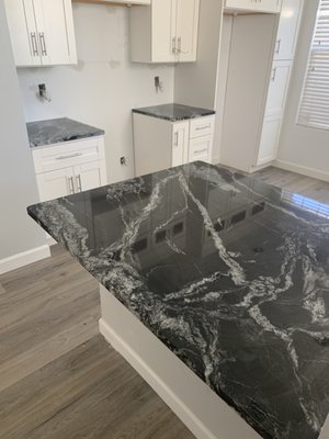 Kitchen Remodel, Granite: Black Forest - One of my favorite remodels we've done so far. We rarely get homeowners who want a dark color for their kitchen, usually they go for a white quartz, but this time they went with a black granite and it really looks good for their kitchen! The name of the color is "Black Forest".