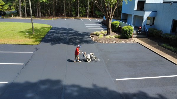 Commercial Services - Marks Sealcoating and Striping offers expert commercial asphalt services backed by 15 years of experience. We specialize in parking lot sealcoating, pavement resurfacing, crack filling, pothole repair, line striping, and traffic marking to enhance safety and curb appeal for businesses. Using premium materials and professional techniques, we deliver durable, high-quality results tailored to commercial properties of all sizes. As a family-owned business, customer satisfaction and timely service are our top priorities. Contact us at (757) 813-2244 for a free estimate.
