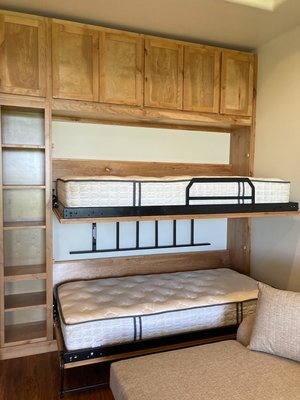 Custom Real Wood Bunk Wall Bed Project - This innovative project reimagines classic bunk beds with modern, space-saving functionality. Designed and built to order, the custom wall bed transforms any room into a flexible, multi-use space—perfect for families, shared bedrooms, or guest accommodations.
Crafted entirely from premium real wood, the bunk wall bed highlights the beauty of natural materials, offering strength, durability, and timeless appeal. By day, both beds fold neatly into the wall, creating valuable floor space for play or work. At night, the beds easily unfold to provide comfortable sleeping quarters without the hassle of traditional setups.
Thoughtful touches, such as integrated safety rails, secure locking mechanisms, and custom finishes, ensure both safety and style. Built-in shelving and optional under-bed storage add even more functionality, making it a truly all-in-one solution for maximizing space. Each detail, from joinery to hardware, reflects meticulous craftsmanship and a dedication to custom design—delivering a versatile bunk bed that seamlessly blends comfort, practicality, and classic real wood aesthetics. Custom Real Wood Bunk Wall Bed Project - This innovative project reimagines classic bunk beds with modern, space-saving functionality. Designed and built to order, the custom wall bed transforms any room into a flexible, multi-use space—perfect for families, shared bedrooms, or guest accommodations.
Crafted entirely from premium real wood, the bunk wall bed highlights the beauty of natural materials, offering strength, durability, and timeless appeal. By day, both beds fold neatly into the wall, creating valuable floor space for play or work. At night, the beds easily unfold to provide comfortable sleeping quarters without the hassle of traditional setups.
Thoughtful touches, such as integrated safety rails, secure locking mechanisms, and custom finishes, ensure both safety and style. Built-in shelving and optional under-bed storage add even more functionality, making it a truly all-in-one solution for maximizing space. Each detail, from joinery to hardware, reflects meticulous craftsmanship and a dedication to custom design—delivering a versatile bunk bed that seamlessly blends comfort, practicality, and classic real wood aesthetics.