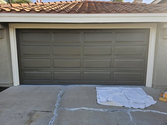 Painted Garage Door - This garage door needed to match the existing HOA color. So we prep and ready garage door for paint. Once ready, we masked off and sprayed.