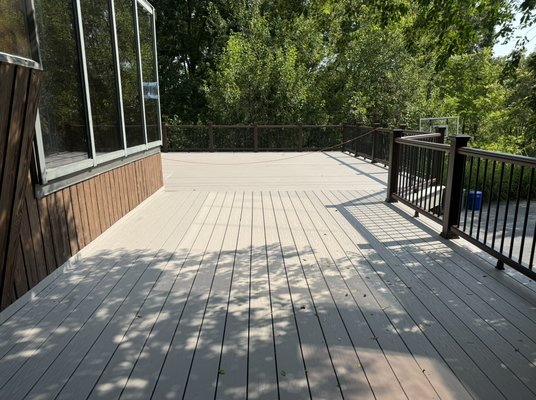 Deck re-surface and new rails. - This deck resurface was done on home that was design with the deck as part of the house when it was originally build. The deck was elevated to serve as a 2 car garage below. Part of the project was to install an under decking system with gutters and downspouts to keep the area below dry. The railing used match perfect with the color siding so it was design to blend with the house. Everything about this project was unique and somewhat complicated. The end result was another satisfied client. Mission accomplished. On to the next fun project. Deck re-surface and new rails. - This deck resurface was done on home that was design with the deck as part of the house when it was originally build. The deck was elevated to serve as a 2 car garage below. Part of the project was to install an under decking system with gutters and downspouts to keep the area below dry. The railing used match perfect with the color siding so it was design to blend with the house. Everything about this project was unique and somewhat complicated. The end result was another satisfied client. Mission accomplished. On to the next fun project.