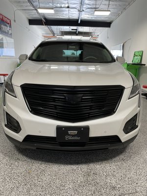 Chrome delete package - This Cadillac came in for a full chrome delete package with custom smoke taillights and gloss black grill with emblems
