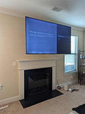 75-inch TV Mounted on Fireplace - This 75-inch TV was mounted on a full motion mount above the fireplace; One of the many that we have done in the past few weeks with the same precision. There was a pre-wired power outlet and HDMI that we connected right away so the customer don't have to worry about it. This project, like others, earned us a 5-stars review on Google.