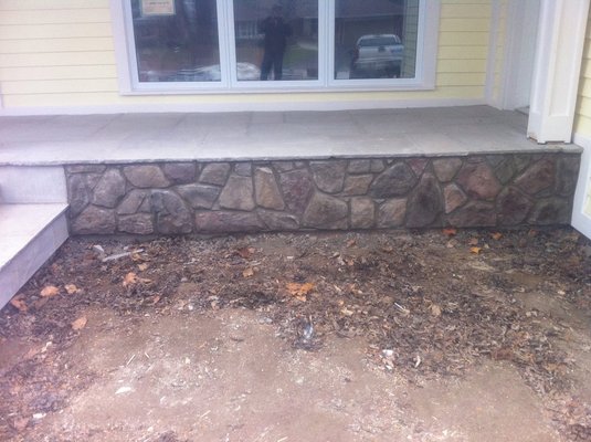 1 inch stones on porch(rock face)
Cultured stones or 1 inch man made stones cemented on foundation and tooled. - 1 inch stones on porch (rock face)
Cultured stones cemented on foundation walls and tooled finish.