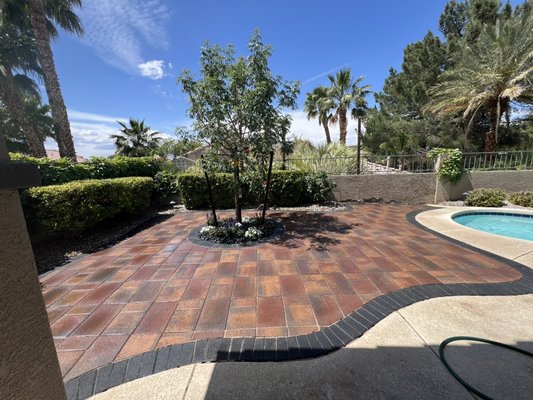 New backyard Project - This backyard was completely remodel by removing old grass , removing old irrigation and dead bushes.
Created a nice sitting area around the pool, with monumental pavers and black border, as well as new irrigation for tree and flower bed . 
New flower bed installation with accent rocks .
