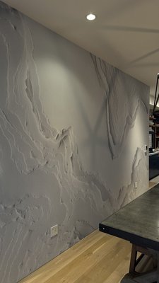 Calico WINTER - Another one of our completed projects with the Calico mural. We were honored to install yet another stunning mural, this time from the TOPOGRAPHIES collection. Now, the dining room has gained a special and unique charm. It's truly breathtaking! The way the colors blend and the design flows, it's like stepping into another world. It's not just a wall anymore; it's a masterpiece that adds soul and character to the entire space. We couldn't be prouder of how it turned out. It's moments like these that remind us why we're so passionate about what we do. Join our clients in the pursuit of transforming their space, and let us help you bring your bold ideas to life. Together, we'll embark on a journey of creativity and innovation, turning your vision into reality.