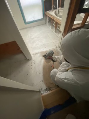 Professional Lead Abatement Service - This tiled master bath suffered a toilet overflow. It was almost completely enclosed with these small ceramic lead-containing tiles; when dealing with haz-mat regulated substances such as Lead or Asbestos, it is not recommended to leave any liability behind for the contractor/vendor following the abatement* process. Therefore if it was determined that some of the affected lead-containing ceramic tiles tiles are unsalvageable and should be removed in order to efficiently clean the surfaces underneath/behind them, our abatement team will remove any and all continuous materials in the same area; when the materials are older, they are also very unlikely to be matched as well.
*Abatement - the professional term that refers to the procedural safe removal and disposal of regulated substances in building materials.