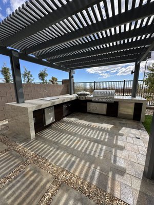 Outdoor Living Area - This projects mission for this customer was to provide usable areas for the family to entertain and not be limited to indoors. We constructed a 10ft x10ft BBQ Island with 42inch grill drawers and mini fridge etc. Approximately 675 Sqft. of Belgard pavers were installed which includes walkway, firepit area, and BBQ Island areas as well. We used approximately 4 tons to fill in planter areas and installed 175 Sqft of artificial turf. Outdoor Living Area - This projects mission for this customer was to provide usable areas for the family to entertain and not be limited to indoors. We constructed a 10ft x10ft BBQ Island with 42inch grill drawers and mini fridge etc. Approximately 675 Sqft. of Belgard pavers were installed which includes walkway, firepit area, and BBQ Island areas as well. We used approximately 4 tons to fill in planter areas and installed 175 Sqft of artificial turf.