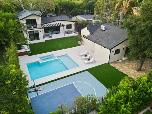 Dynamic Backyard Remodel in Encino, CA - This outdoor transformation delivers the perfect blend of recreation and relaxation, turning your backyard into a resort-style oasis that promotes healthier, happier living for the whole family. The pool remodel included resurfacing with a modern, durable finish, new tile work, upgraded energy-efficient lighting, and the addition of a sleek Baja shelf for stylish lounging—all designed for effortless enjoyment and long-lasting value. Surrounding hardscape was refreshed to match the clean, contemporary look, incorporating low-maintenance artificial turf for an eco-friendly touch that saves time and water. Adjacent to the pool, we built a custom basketball court with professional-grade surfacing, clear backboard, and perimeter lighting for seamless day-to-night play, boosting fun and fitness without overpaying. Together, these upgrades create a dynamic space built for both fun and functionality, completed with minimal disruption and at competitive prices that exceed expectations while enhancing your property's appeal. Services include: Pool Resurfacing, Tile Installation, Lighting Upgrades, Baja Shelf Addition, Hardscape Refresh, Artificial Turf Integration, Basketball Court Construction, Professional Surfacing, Perimeter Lighting, and Custom Outdoor Design. Dynamic Backyard Remodel in Encino, CA - This outdoor transformation delivers the perfect blend of recreation and relaxation, turning your backyard into a resort-style oasis that promotes healthier, happier living for the whole family. The pool remodel included resurfacing with a modern, durable finish, new tile work, upgraded energy-efficient lighting, and the addition of a sleek Baja shelf for stylish lounging—all designed for effortless enjoyment and long-lasting value. Surrounding hardscape was refreshed to match the clean, contemporary look, incorporating low-maintenance artificial turf for an eco-friendly touch that saves time and water. Adjacent to the pool, we built a custom basketball court with professional-grade surfacing, clear backboard, and perimeter lighting for seamless day-to-night play, boosting fun and fitness without overpaying. Together, these upgrades create a dynamic space built for both fun and functionality, completed with minimal disruption and at competitive prices that exceed expectations while enhancing your property's appeal. Services include: Pool Resurfacing, Tile Installation, Lighting Upgrades, Baja Shelf Addition, Hardscape Refresh, Artificial Turf Integration, Basketball Court Construction, Professional Surfacing, Perimeter Lighting, and Custom Outdoor Design.