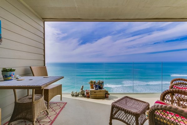Vacation Rental - Surfsong - Situated on farthest Western point of Solana Beach, this beautiful San Diego oceanfront rental will take your breath away as you walk through the door. This condo houses a perfect getaway for both luxury and relaxation in this private, peaceful Southern California beach town.  Need to work?  This unit has incredibly fast panoramic wifi to make your work from home needs a breeze. You'll find nautical decor and color scheme throughout this 2 bedroom, 2 bathroom unit illuminated by the turquoise ocean just outside the windows. There is 1 king bed in the Master bedroom, 1 queen bed in the second bedroom, and a wrap-around couch in the living room-- this does not fold out. Upgrades are sprinkled throughout including a huge flat screen TV in the living room area neighboring the fully equipped kitchen. Enjoy the luxury of private parking and laundry or venture down to the community area and pool/BBQ.
