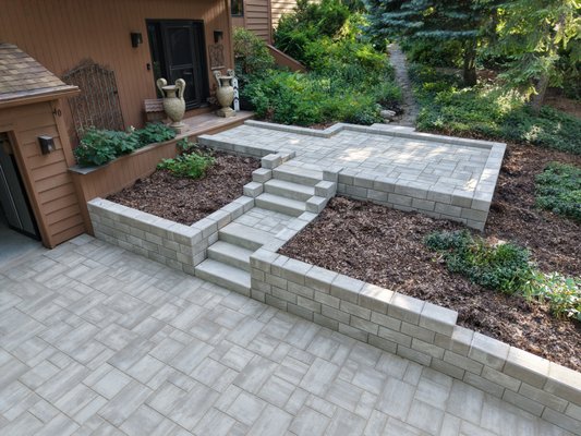 Luxury Driveway, Walkway & Entryway Transformation - Luxury Driveway, Walkway & Entryway Transformation
This project completely transformed the front approach to this home with a custom brick paver driveway, elevated entry walkway, retaining walls, and architectural steps. The design was carefully engineered to navigate significant grade changes while creating a grand entrance that complements the home’s natural wooded setting.
Built on a properly prepared aggregate foundation, this installation features premium concrete pavers, retaining walls, and custom stair systems designed for long-term performance, drainage, and curb appeal. The result is a beautiful, functional outdoor space that dramatically enhances both the appearance and value of the property.
Services: Brick Paver Driveway • Walkway Installation • Retaining Walls • Steps • Front Entry Design • Hardscape Construction • Luxury Outdoor Living
#MissionBrickPaving #BrickPaverDriveway #RetainingWalls #WalkwayInstallation #HardscapeDesign #LuxuryOutdoorLiving #CurbAppeal #PaverDriveway #ChicagolandHardscapes #OutdoorLivingExperts Luxury Driveway, Walkway & Entryway Transformation - Luxury Driveway, Walkway & Entryway Transformation
This project completely transformed the front approach to this home with a custom brick paver driveway, elevated entry walkway, retaining walls, and architectural steps. The design was carefully engineered to navigate significant grade changes while creating a grand entrance that complements the home’s natural wooded setting.
Built on a properly prepared aggregate foundation, this installation features premium concrete pavers, retaining walls, and custom stair systems designed for long-term performance, drainage, and curb appeal. The result is a beautiful, functional outdoor space that dramatically enhances both the appearance and value of the property.
Services: Brick Paver Driveway • Walkway Installation • Retaining Walls • Steps • Front Entry Design • Hardscape Construction • Luxury Outdoor Living
#MissionBrickPaving #BrickPaverDriveway #RetainingWalls #WalkwayInstallation #HardscapeDesign #LuxuryOutdoorLiving #CurbAppeal #PaverDriveway #ChicagolandHardscapes #OutdoorLivingExperts