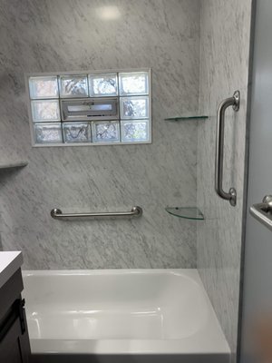 Bathroom Remodel 2023 - This remodel was done on a bathroom to make it handicap-accessible. It included removing shower doors; installing safety grab bars; replacing the old vanity with a taller one with sliding cabinet doors; replacing the old toilet with one at higher ADA accessible height; and installing all new floor tile, tub surround, shelving, countertop, and fixtures. Bathroom Remodel 2023 - This remodel was done on a bathroom to make it handicap-accessible. It included removing shower doors; installing safety grab bars; replacing the old vanity with a taller one with sliding cabinet doors; replacing the old toilet with one at higher ADA accessible height; and installing all new floor tile, tub surround, shelving, countertop, and fixtures.