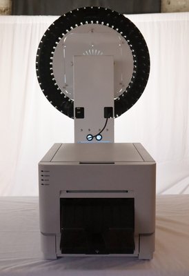 Photo Booth Printer - The Photo Booth Printer is an obvious choice to add to your next event. While guests can digitally share their photos, why not share a physical party favor? Let us help you customize your layouts and create physical memories for your guests.