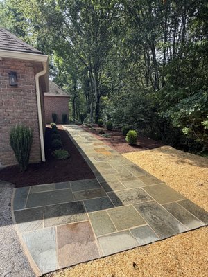 Natural Stone Walkway Installation - This customer wanted to reuse their old existing flagstone. We cleaned it up and installed a wet laid flagstone walkway as well as new low maintenance plantings and landscape lighting. Natural Stone Walkway Installation - This customer wanted to reuse their old existing flagstone. We cleaned it up and installed a wet laid flagstone walkway as well as new low maintenance plantings and landscape lighting.