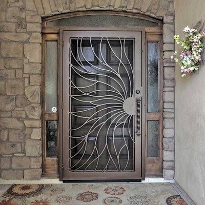 Iron Security Doors - First Impression Ironworks’ custom made exterior metal security screen doors are handmade from 100% American steel. Also called storm doors in many parts of the country, these security screen doors will improve your home with the strength, security and beauty of wrought iron. Plus, our security doors are built to last. We have been building and installing custom security doors that are 100% American made steel products for more than 25 years right here in Arizona. You can order a security storm door for a front door, Arcadia door, double French doors, and even provide security for your sliding glass patio doors. We also can customize your door to include glass and copper inserts. Ask your First Impression Security Door specialist for all the options available.